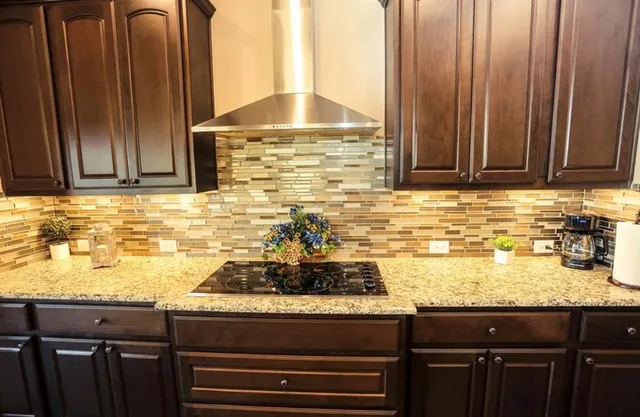 a kitchen with granite countertop cabinets and stove