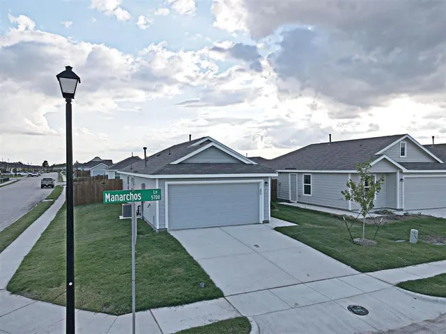 a front view of a house with a garden and yard