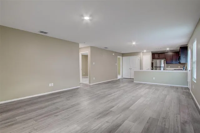 a view of a kitchen with wooden floor and a kitchen