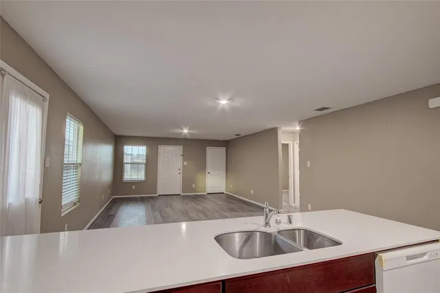 a kitchen with stainless steel appliances a sink and a window