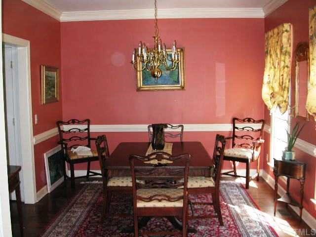 4412 Queenstown Court Raleigh, NC 27612 - Photo 2 of 11 a view of a dining room with furniture window and wooden floor