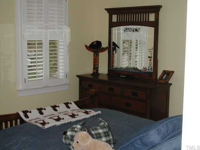 4412 Queenstown Court Raleigh, NC 27612 - Photo 9 of 11 a bed sitting in a bedroom next to a window
