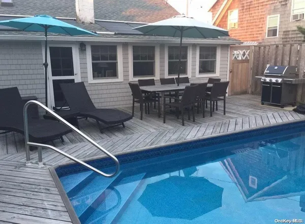 a view of a patio with table and chairs