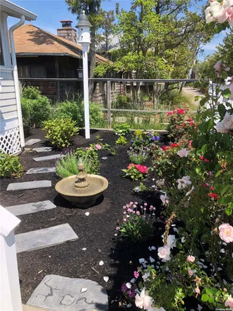 a view of a house with fountain in a yard