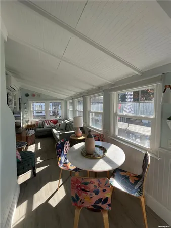 a living room with furniture a window and a table