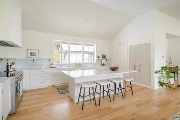 a dining room with furniture and potted plants