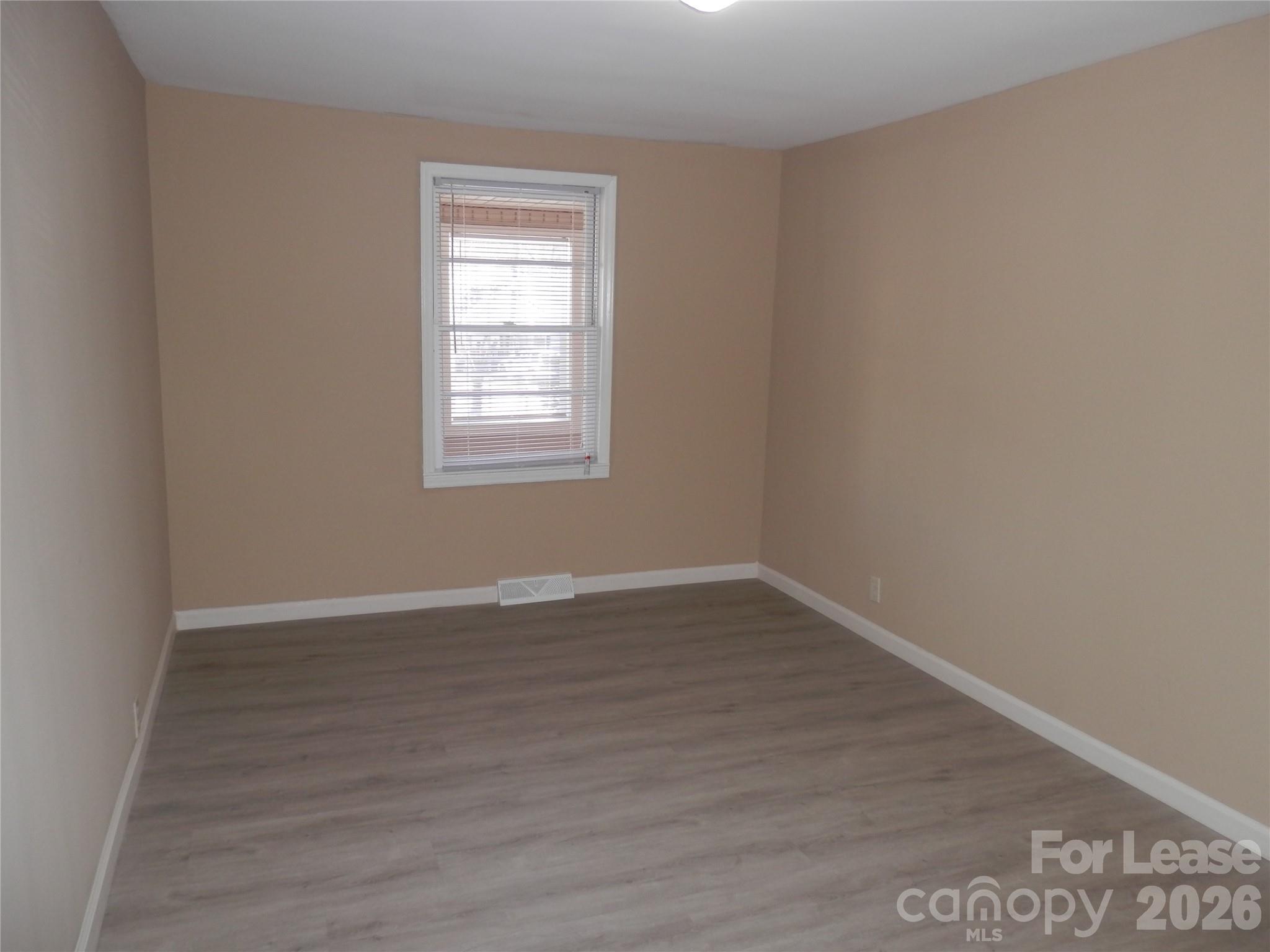 67 Barber Street Northwest Concord, NC 28027 - Photo 11 of 27 wooden floor in an empty room with a window