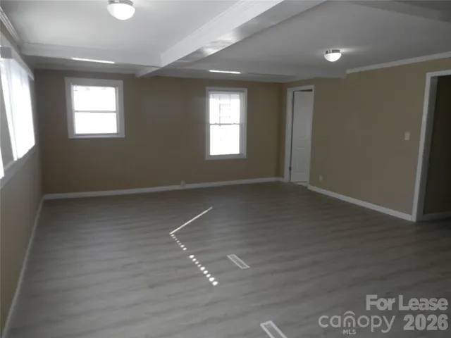 a view of a kitchen with a sink and a refrigerator