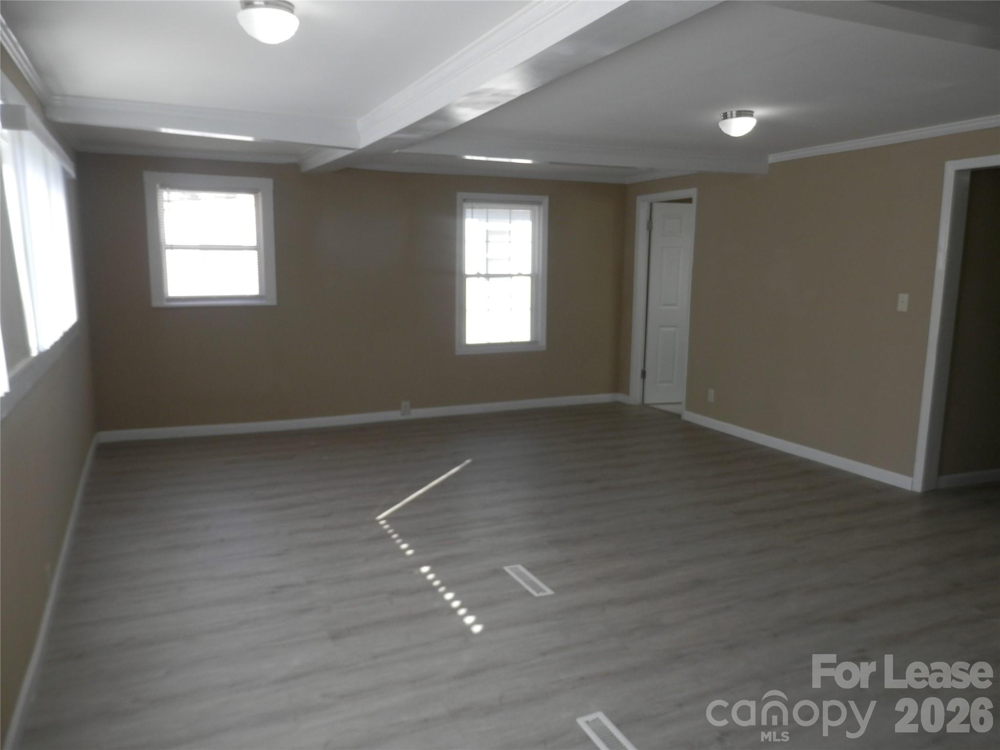 67 Barber Street Northwest Concord, NC 28027 - Photo 17 of 27 an empty room with wooden floor and windows