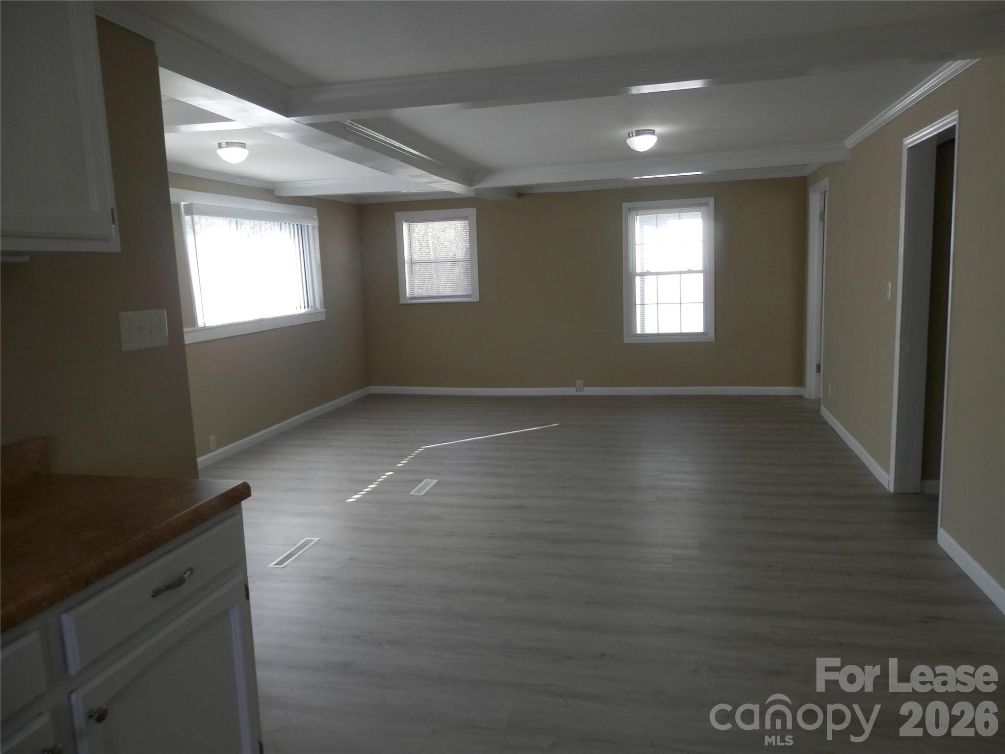67 Barber Street Northwest Concord, NC 28027 - Photo 21 of 27 a view of an empty room with wooden floor and a window