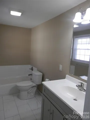 a bathroom with a toilet and a bathtub