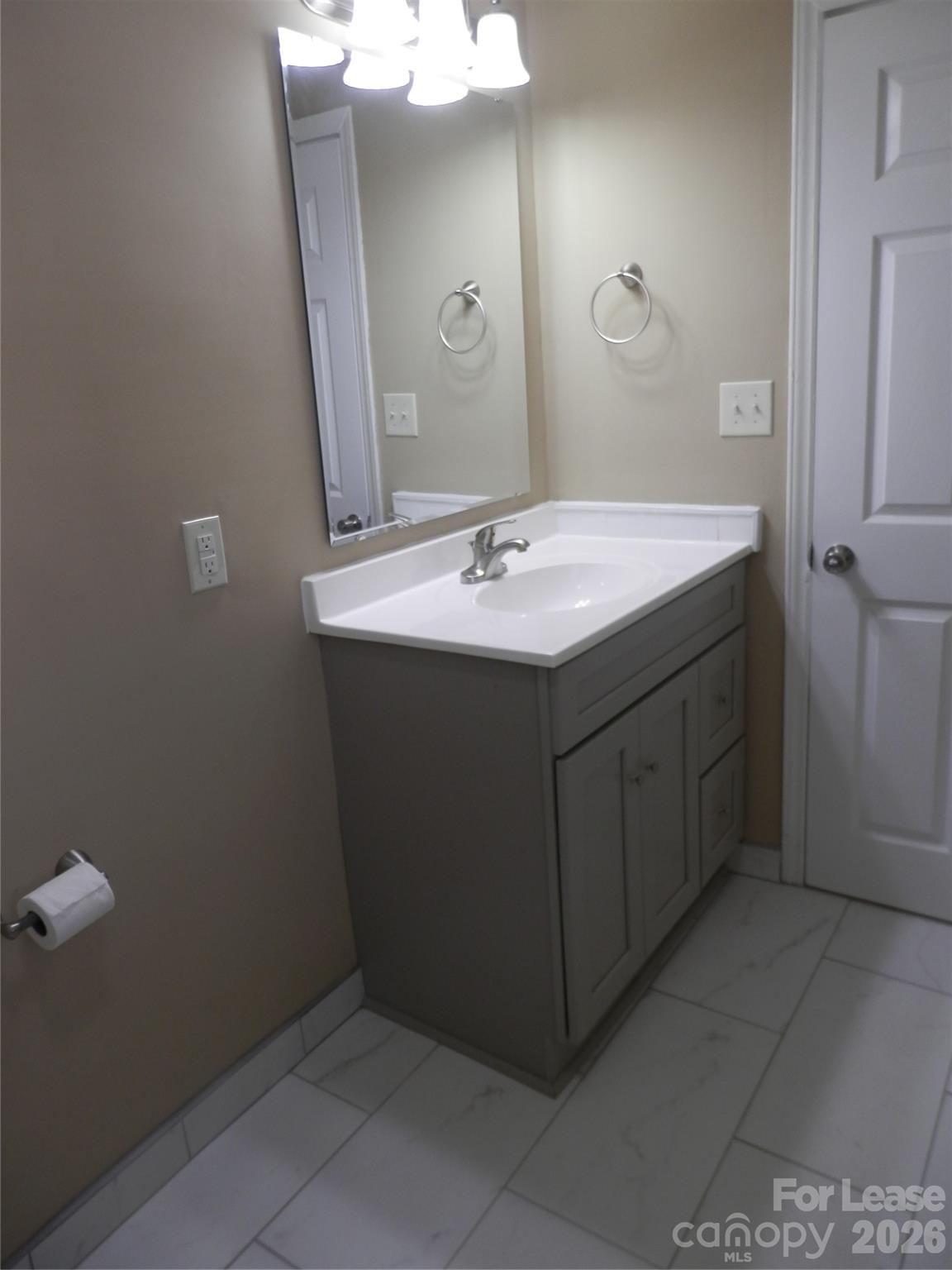 67 Barber Street Northwest Concord, NC 28027 - Photo 26 of 27 a bathroom with a sink and a mirror