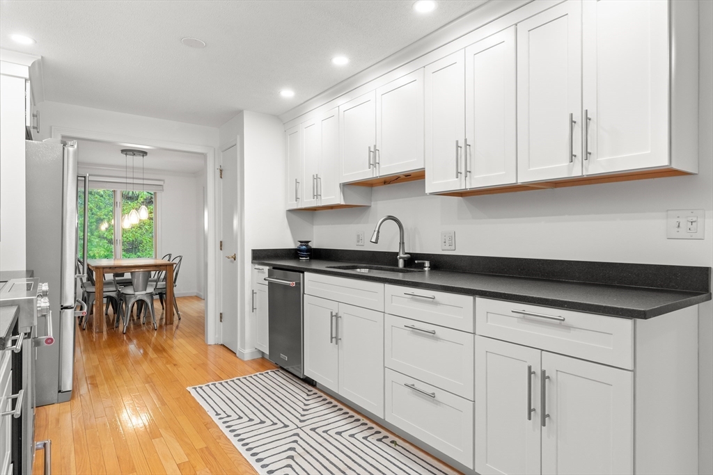 7 Carriage Way Danvers, MA 01923 - Photo 5 of 31 a kitchen with granite countertop a sink a stove and cabinets
