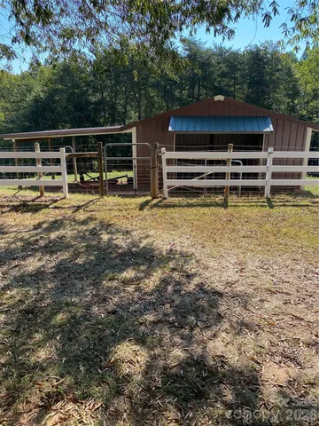 a view of a blue house with a yard