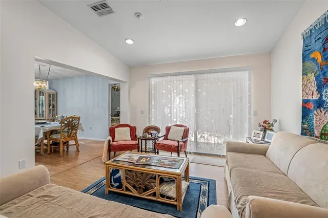 a living room with furniture a dining table and a flat screen tv