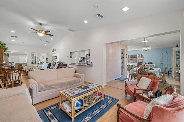 a living room with furniture a table and chairs