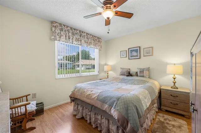 a spacious bedroom with a bed and a chandelier