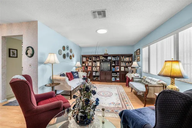 a living room with furniture and a lamp