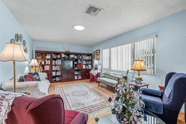 a living room with furniture and a lamp