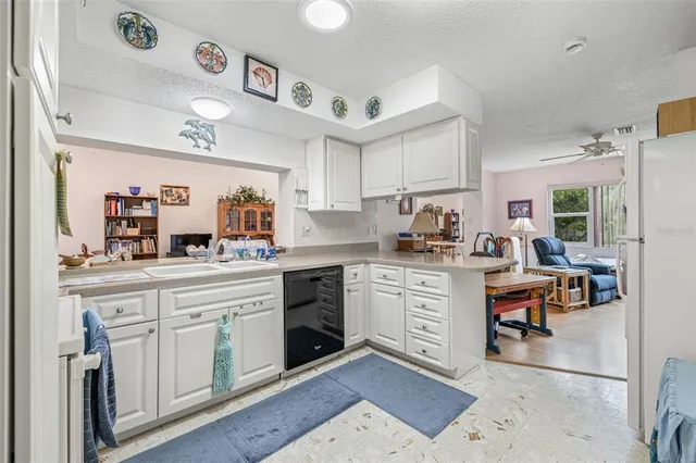 a kitchen with cabinets and window