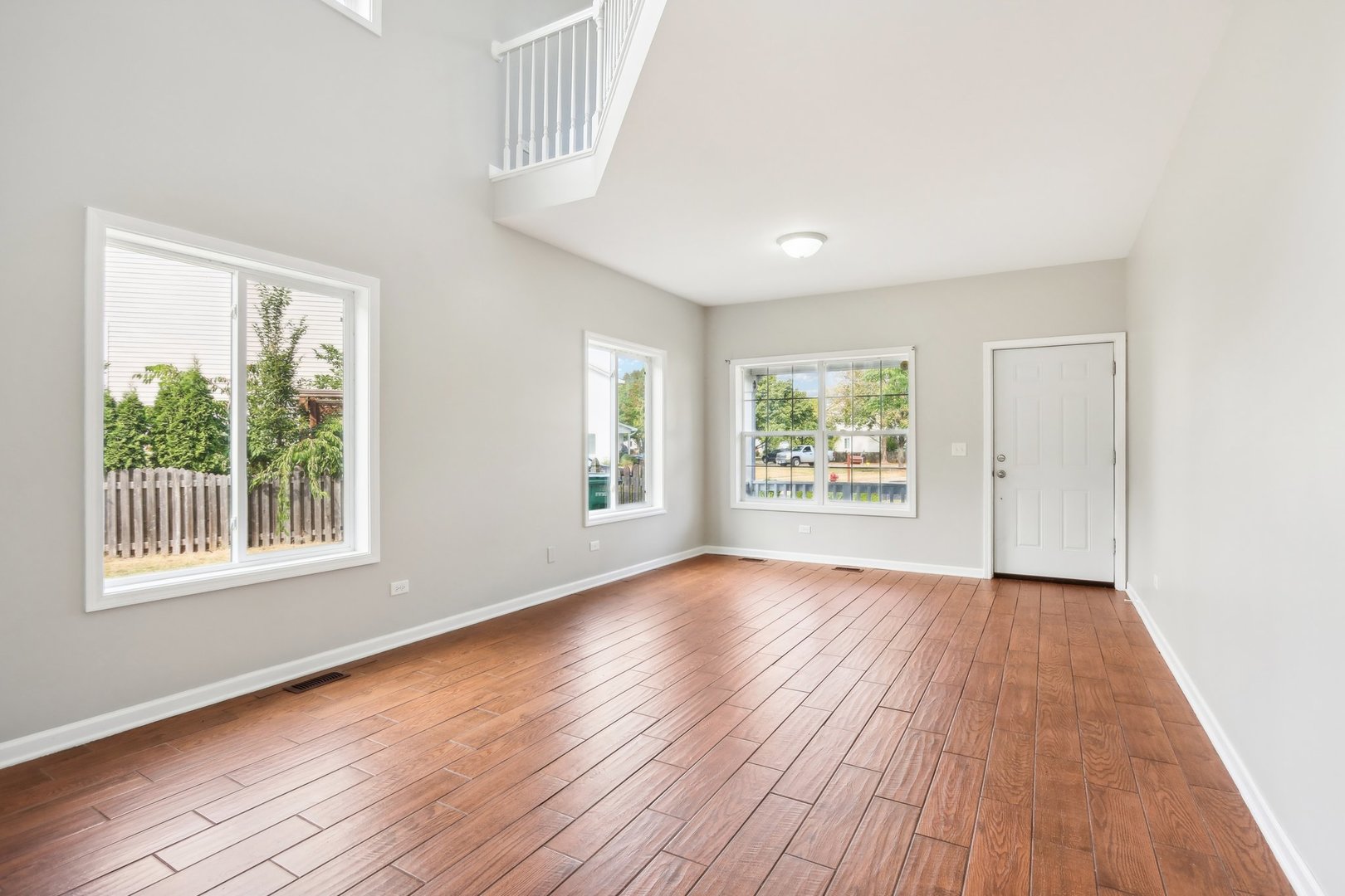 346 Richfield Trail Romeoville, IL 60446 - Photo 4 of 32 an empty room with wooden floor and windows