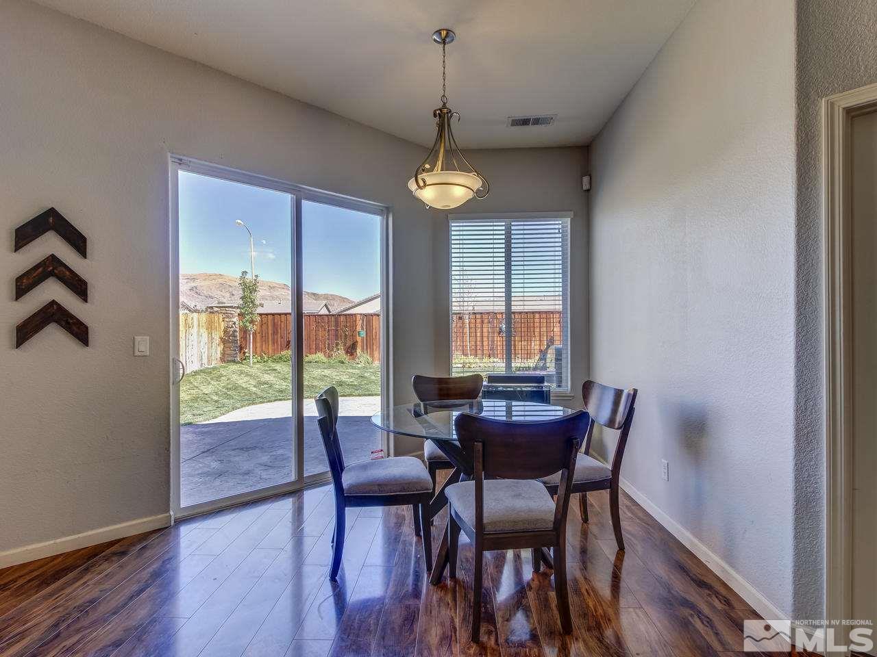 9620 Frankwood Drive Reno, NV 89521 - Photo 13 of 25 a dining room with furniture a chandelier and wooden floor