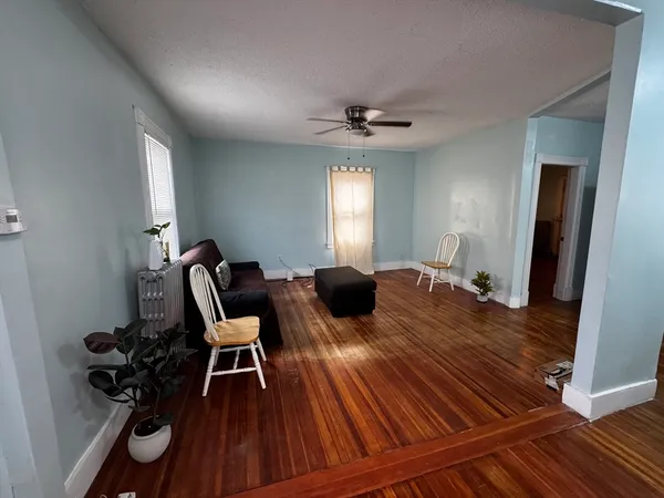 a view of a workspace with furniture and wooden floor
