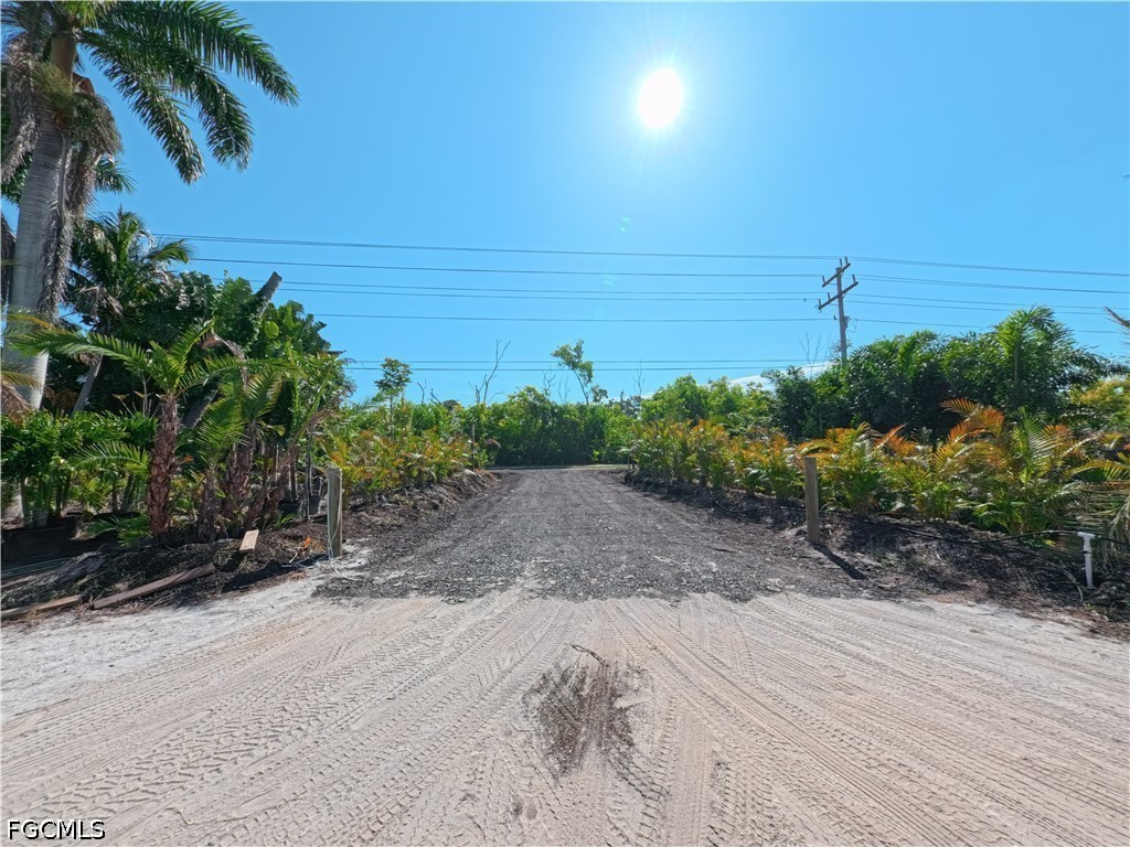 11851 Stringfellow Road Bokeelia, FL 33922 - Photo 15 of 26 a view of a dry yard with wooden fence