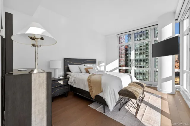 a bedroom with a bed and a flat screen tv