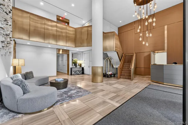 a living room with couches and kitchen view