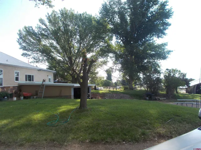 a view of a house with a yard covered in snow