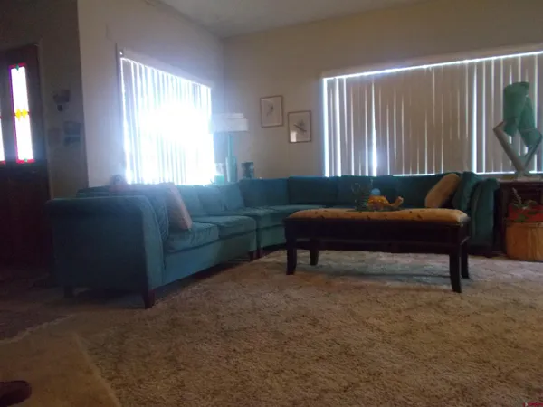 a view of a livingroom with furniture and a bookshelf
