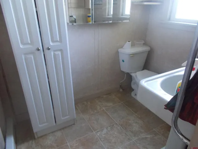 a kitchen with a sink a stove and cabinets