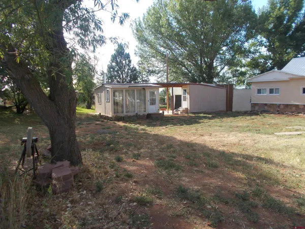 a view of a back yard of a house