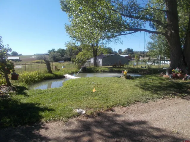a view of a field with wooden fence