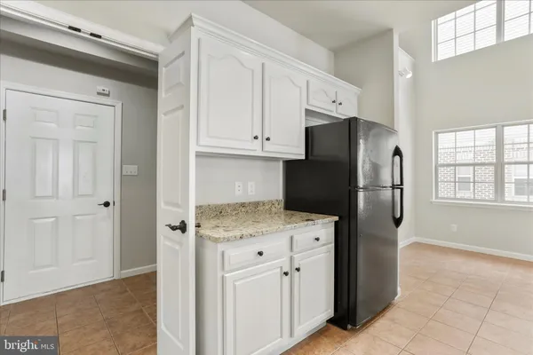 a kitchen with stainless steel appliances granite countertop a refrigerator and a stove