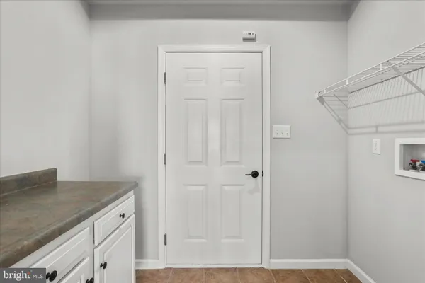 a view of bathroom with granite countertop cabinets