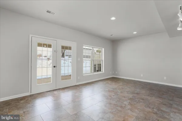 an empty room with a empty space and windows