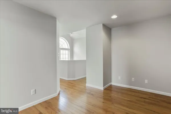a bathroom with a granite countertop toilet a sink and a mirror