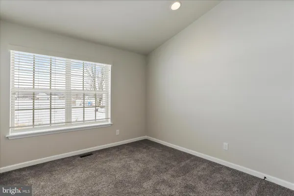 a view of an empty room with closet area