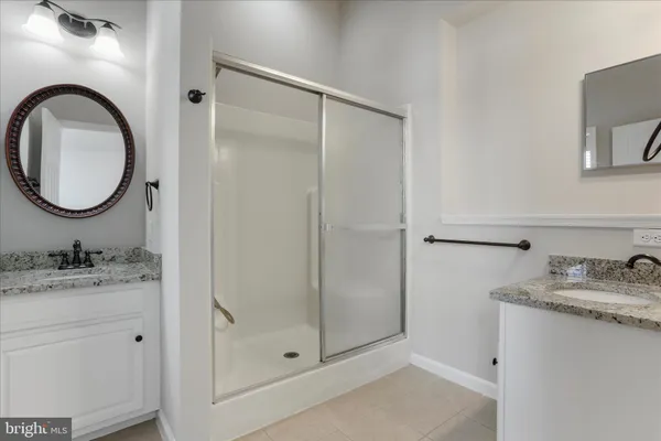 a bathroom with a granite countertop toilet sink and mirror