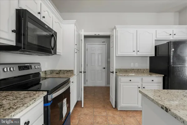 a kitchen with a stove microwave and refrigerator