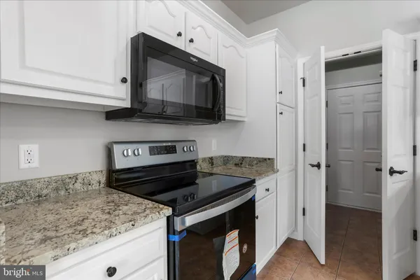 a kitchen with a stove and a microwave