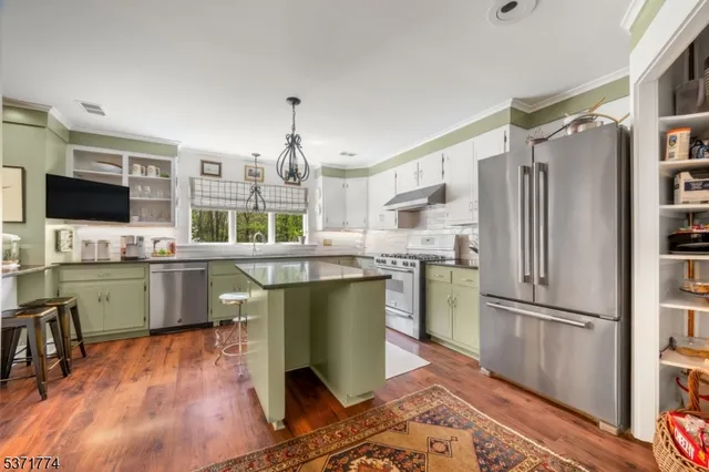 a dining room with furniture a rug and a large window