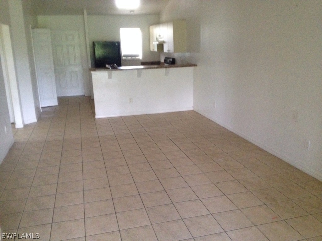 4533 26th Street Southwest Lehigh Acres, FL 33973 - Photo 8 of 10 a view of a kitchen with an empty space and a sink