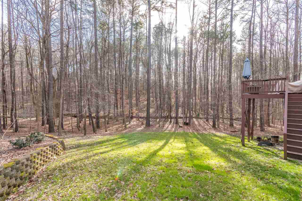 6020 Wild Orchid Trail Raleigh, NC 27613 - Photo 24 of 26 Surrounded by nature! This vacant land behind and beside the home is owned by the HOA and cannot be built on. So it feels like you are living on acres of private woods! Trees!