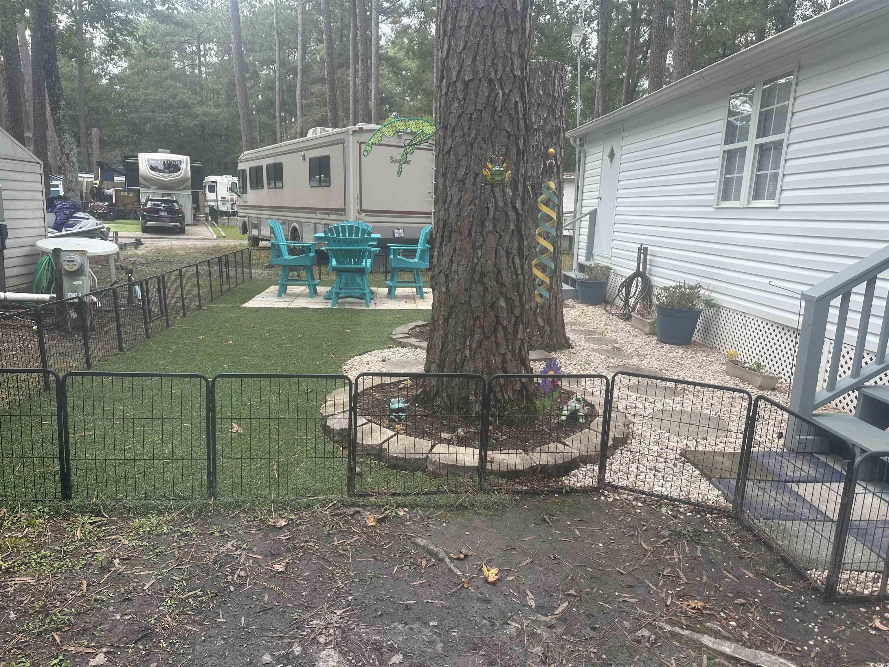613-431 5th Avenue South Myrtle Beach, SC 29577 - Photo 2 of 36 Fenced backyard featuring a patio area and view of wooded area