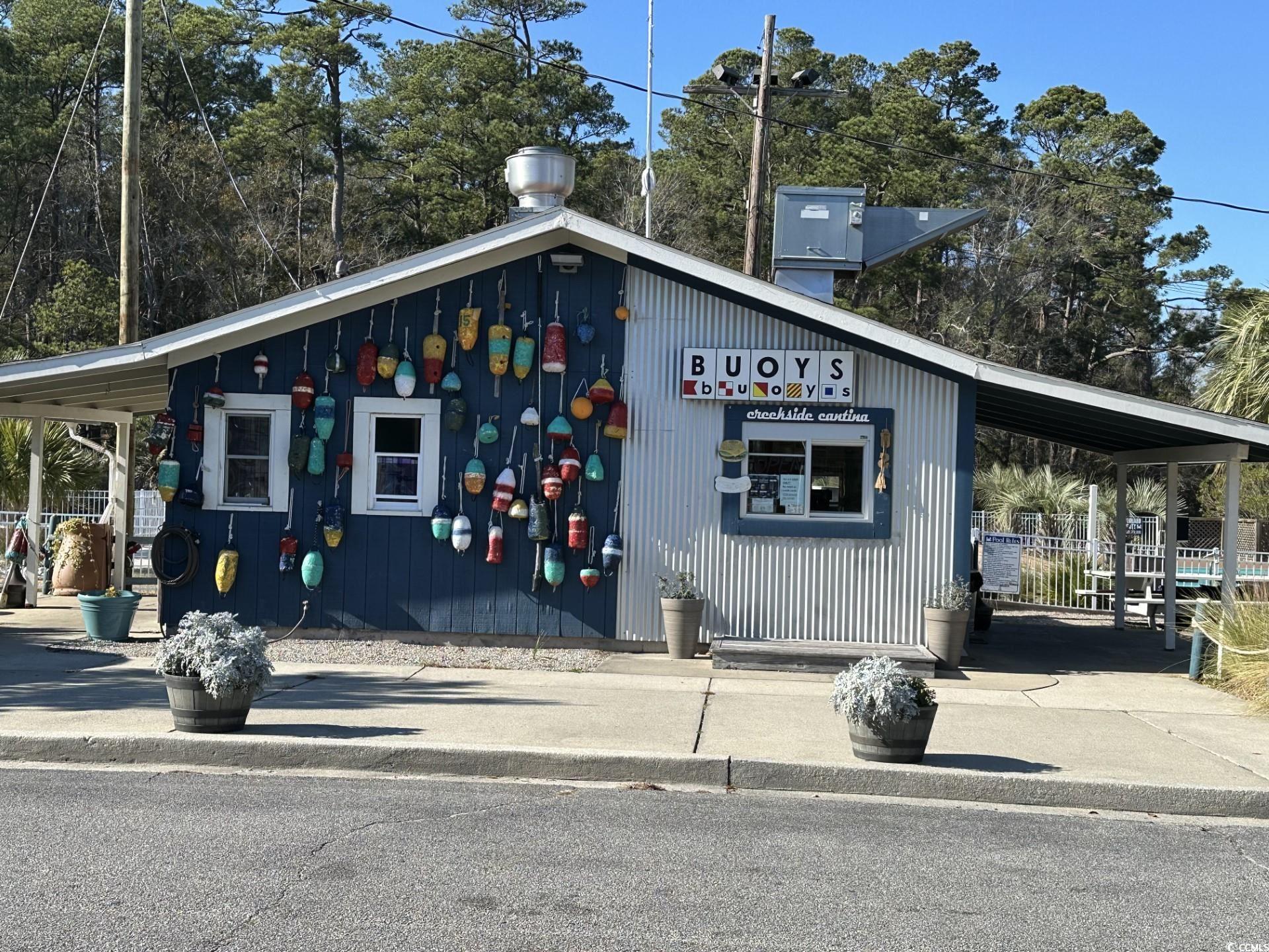 613-431 5th Avenue South Myrtle Beach, SC 29577 - Photo 29 of 36 View of building exterior with a carport and concrete driveway