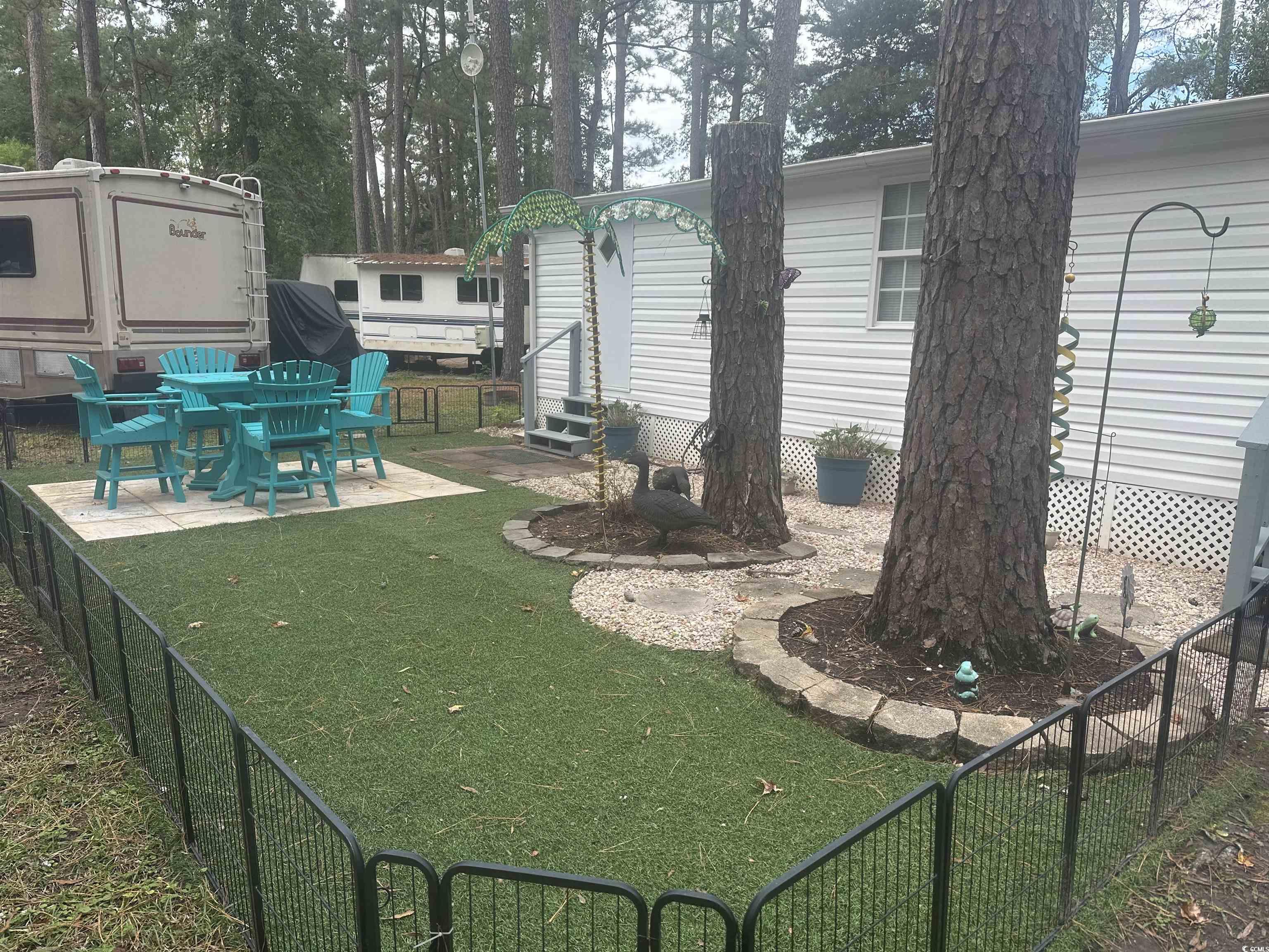 613-431 5th Avenue South Myrtle Beach, SC 29577 - Photo 3 of 36 View of yard featuring a patio area, entry steps, and an outdoor structure