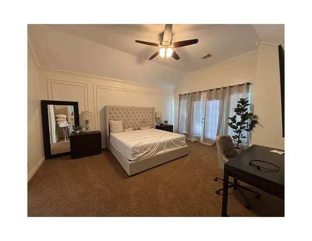 a bedroom with a bed window and potted plant